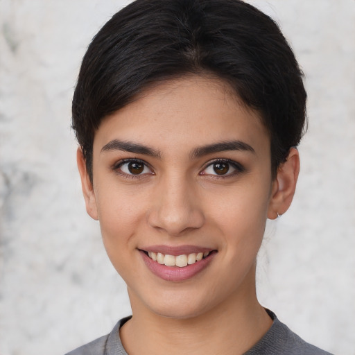 Joyful white young-adult female with short  black hair and brown eyes