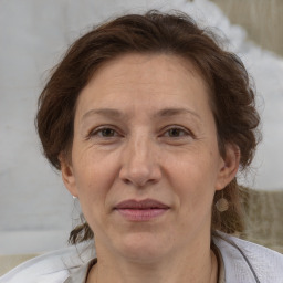 Joyful white adult female with medium  brown hair and brown eyes