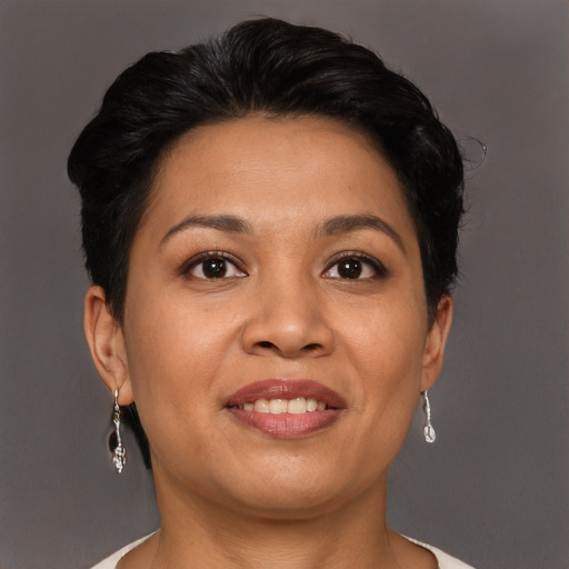 Joyful latino adult female with short  brown hair and brown eyes