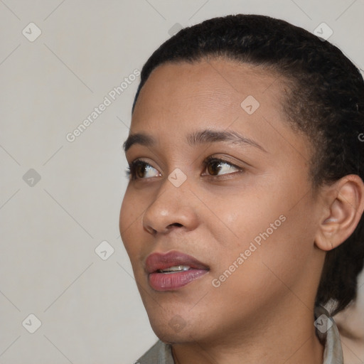 Joyful black young-adult female with short  black hair and brown eyes