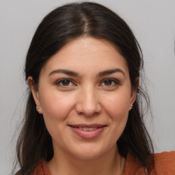 Joyful white young-adult female with medium  brown hair and brown eyes