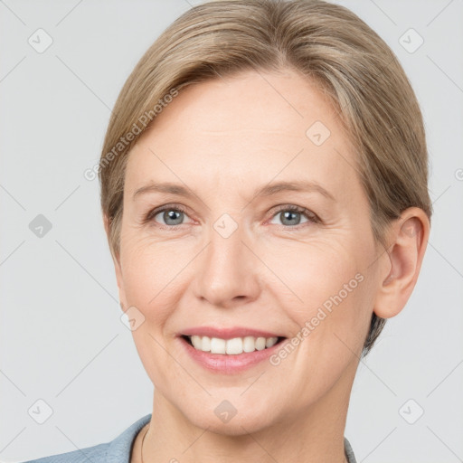 Joyful white adult female with short  brown hair and grey eyes