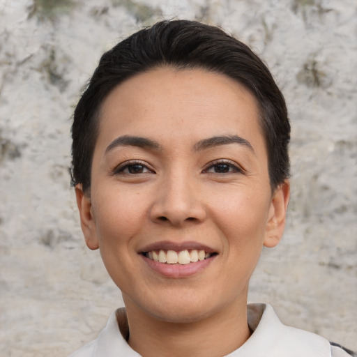 Joyful white young-adult female with short  black hair and brown eyes