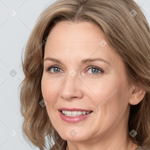 Joyful white adult female with medium  brown hair and blue eyes