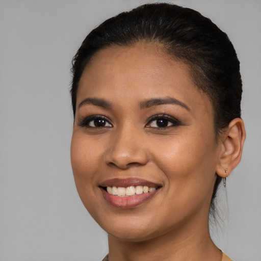 Joyful latino young-adult female with short  brown hair and brown eyes