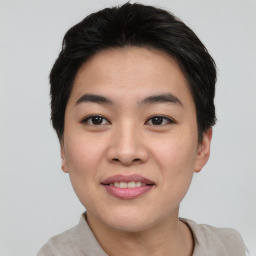 Joyful asian young-adult female with short  brown hair and brown eyes