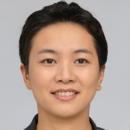 Joyful asian young-adult female with short  brown hair and brown eyes