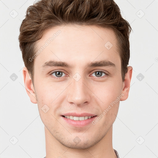 Joyful white young-adult male with short  brown hair and grey eyes