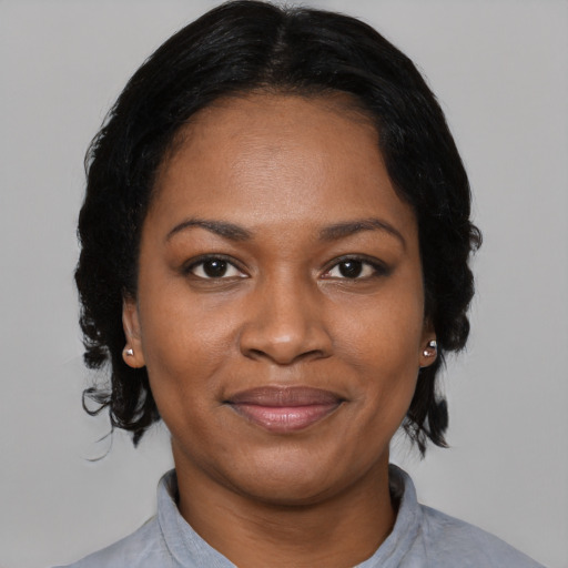 Joyful black young-adult female with medium  black hair and brown eyes