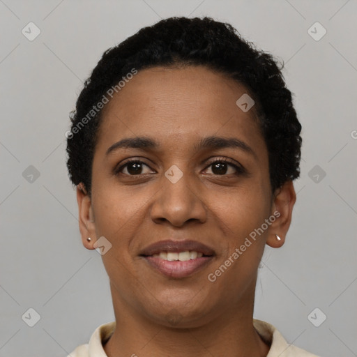 Joyful black young-adult female with short  black hair and brown eyes