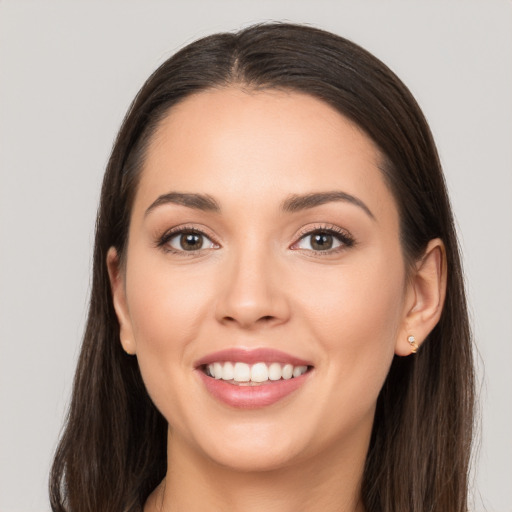 Joyful white young-adult female with long  brown hair and brown eyes