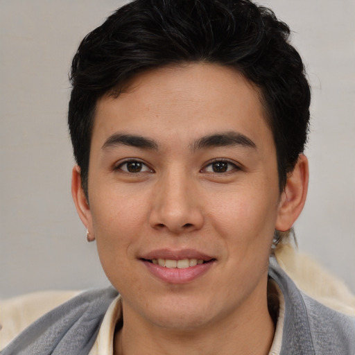 Joyful asian young-adult male with short  brown hair and brown eyes