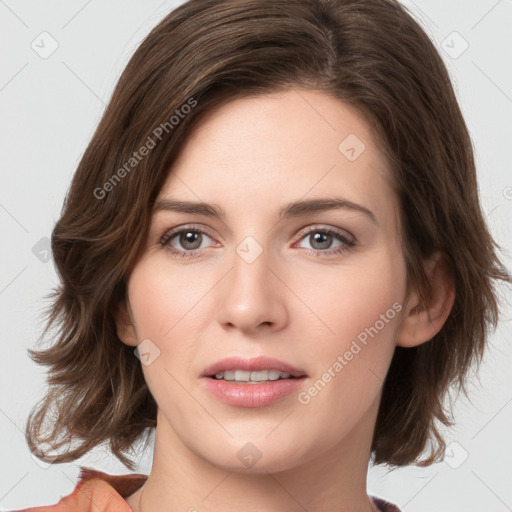 Joyful white young-adult female with medium  brown hair and green eyes