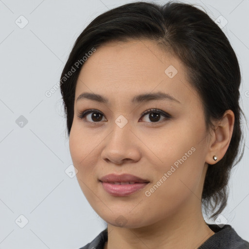 Joyful asian young-adult female with medium  brown hair and brown eyes