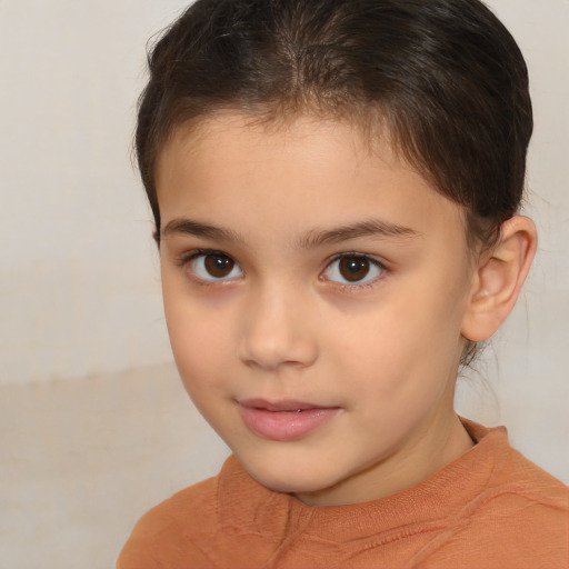 Joyful white child female with short  brown hair and brown eyes