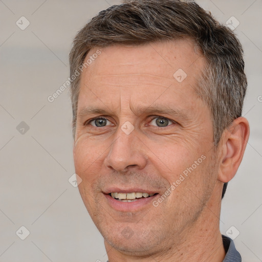 Joyful white adult male with short  brown hair and brown eyes