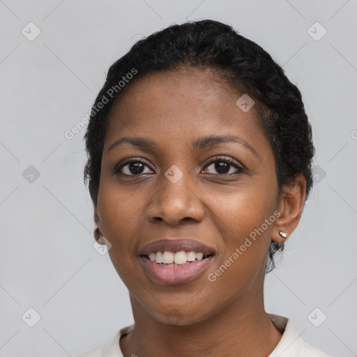 Joyful black young-adult female with short  black hair and brown eyes