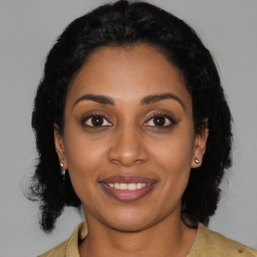Joyful black young-adult female with medium  black hair and brown eyes