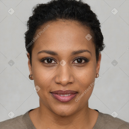 Joyful black young-adult female with short  black hair and brown eyes