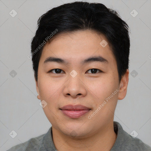 Joyful asian young-adult male with short  black hair and brown eyes