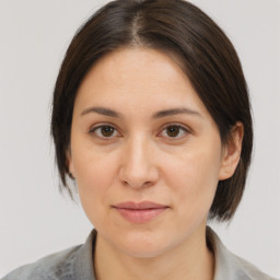 Joyful white adult female with medium  brown hair and brown eyes