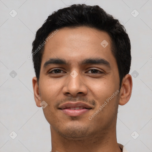 Joyful latino young-adult male with short  black hair and brown eyes