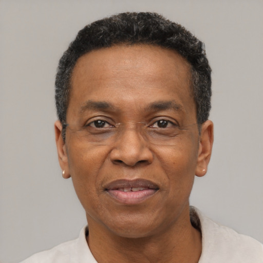 Joyful black adult male with short  black hair and brown eyes