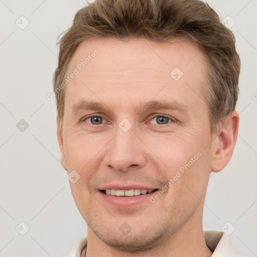 Joyful white adult male with short  brown hair and grey eyes