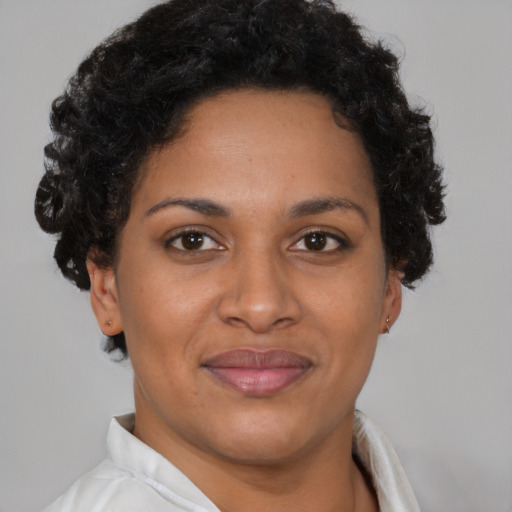 Joyful latino young-adult female with short  brown hair and brown eyes
