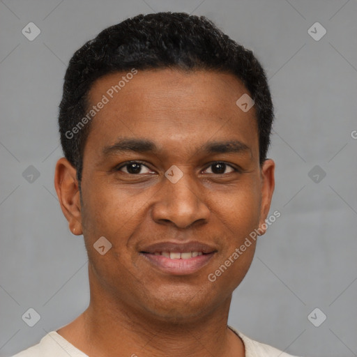 Joyful black young-adult male with short  brown hair and brown eyes