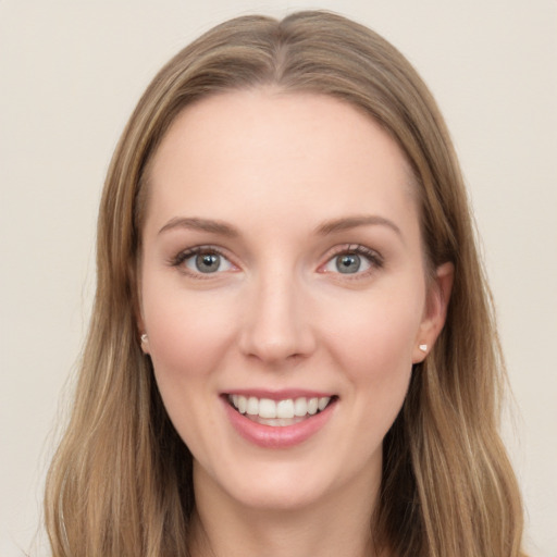 Joyful white young-adult female with long  brown hair and blue eyes