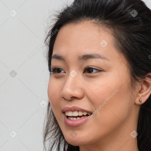 Joyful asian young-adult female with long  brown hair and brown eyes