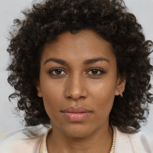 Neutral black young-adult female with medium  brown hair and brown eyes