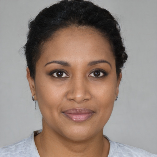 Joyful black young-adult female with short  brown hair and brown eyes