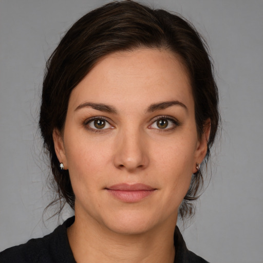 Joyful white young-adult female with medium  brown hair and brown eyes