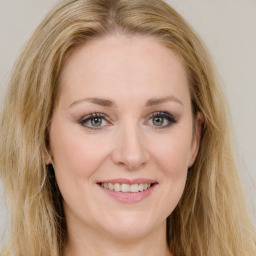 Joyful white young-adult female with long  brown hair and green eyes