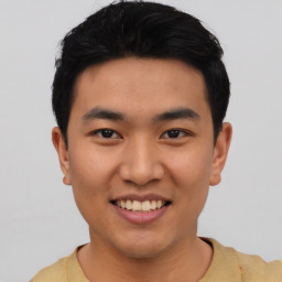 Joyful asian young-adult male with short  black hair and brown eyes