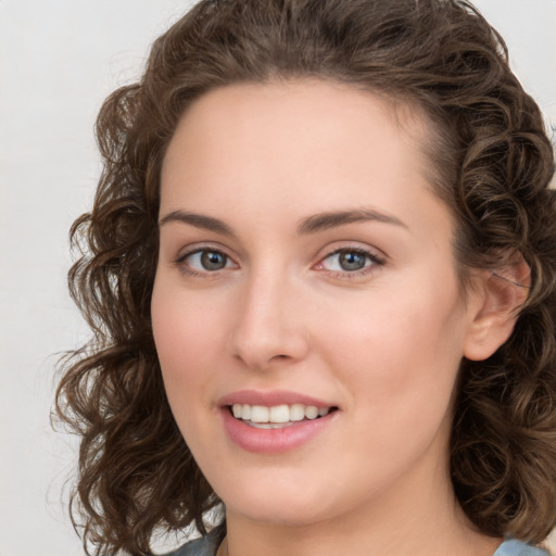 Joyful white young-adult female with medium  brown hair and green eyes