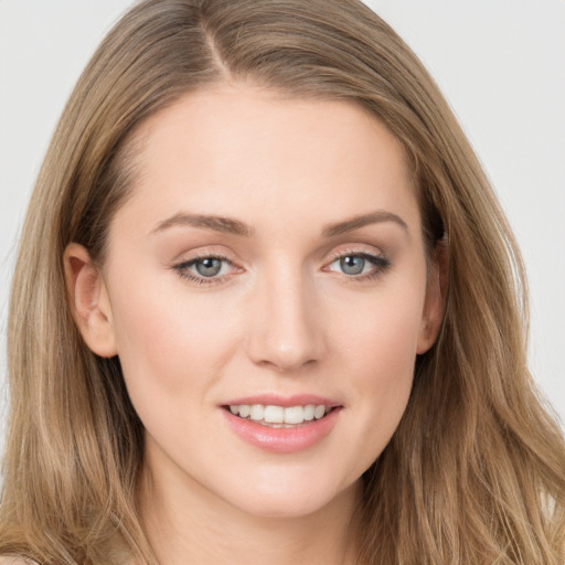 Joyful white young-adult female with long  brown hair and grey eyes