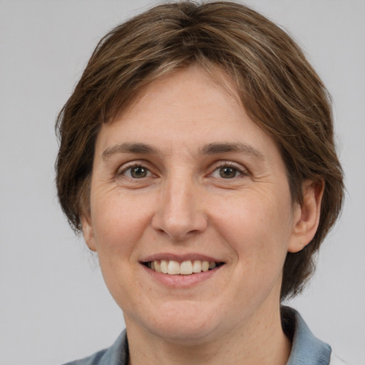 Joyful white adult female with medium  brown hair and brown eyes