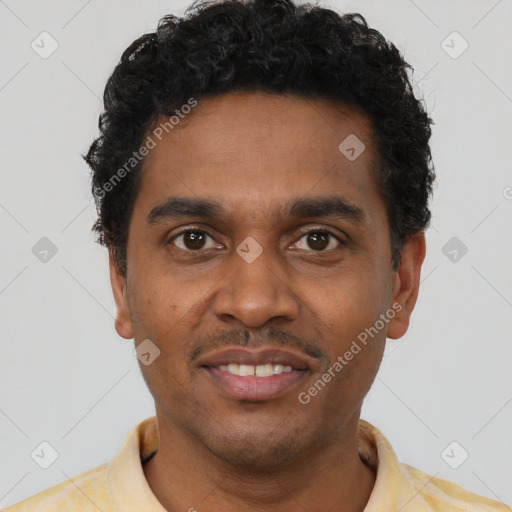 Joyful black young-adult male with short  black hair and brown eyes