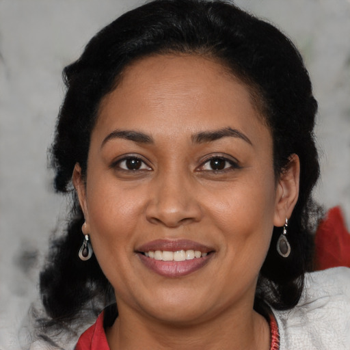 Joyful latino adult female with medium  brown hair and brown eyes