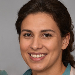 Joyful white adult female with medium  brown hair and brown eyes