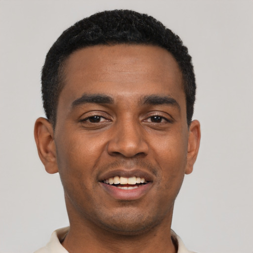 Joyful black young-adult male with short  black hair and brown eyes