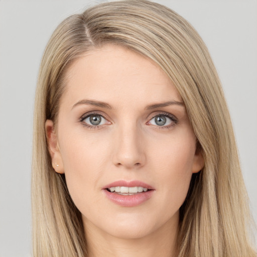 Joyful white young-adult female with long  brown hair and blue eyes