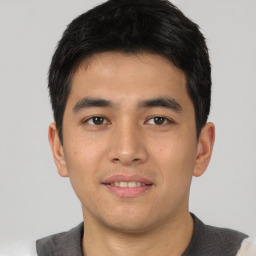 Joyful asian young-adult male with short  black hair and brown eyes