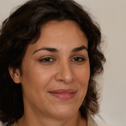 Joyful white adult female with medium  brown hair and brown eyes