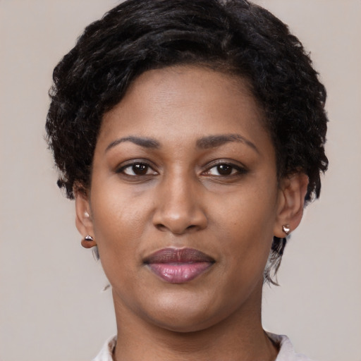 Joyful black young-adult female with short  brown hair and brown eyes