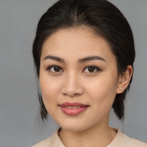 Joyful asian young-adult female with medium  brown hair and brown eyes