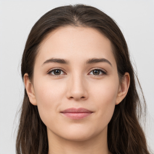 Joyful white young-adult female with long  brown hair and grey eyes